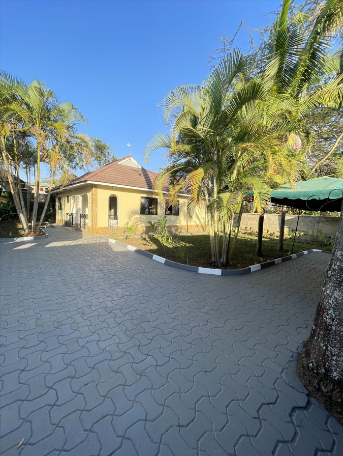 Front of home with secure gate and driveway